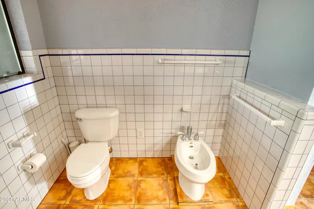 a bathroom with a toilet and a shower curtain