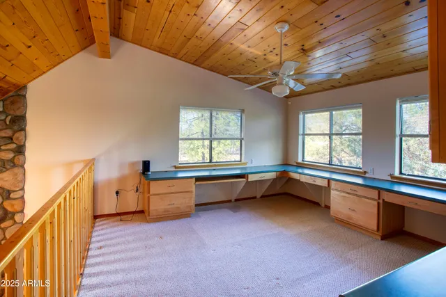 a large room with a large window and furniture