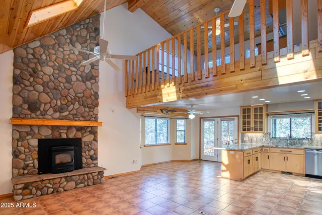 a living room with furniture and a dining table with wooden floor