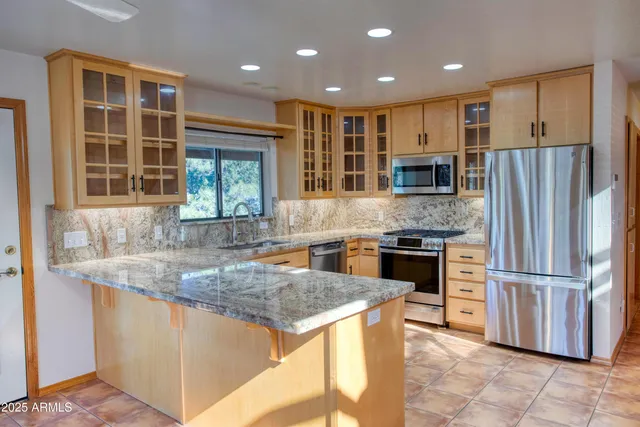 a kitchen with refrigerator cabinets and dining table