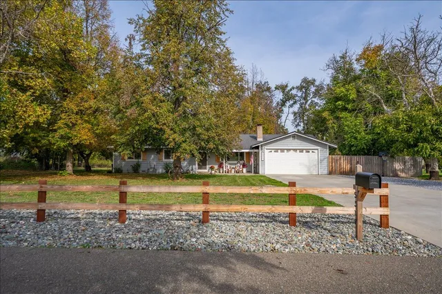 a view of a house with a yard and sitting area