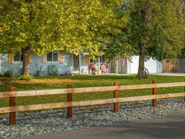 a living room with furniture a fireplace and a chandelier