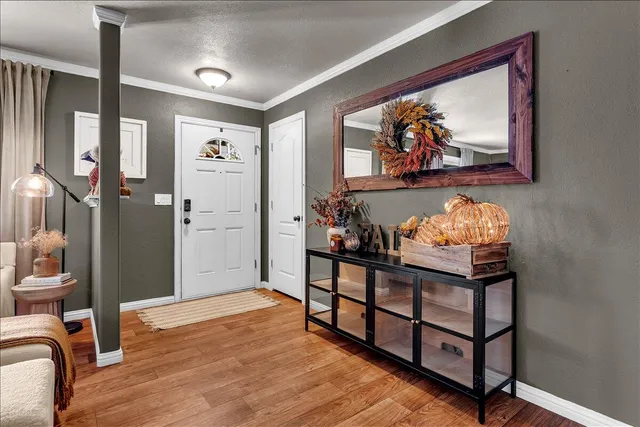 a living room with furniture a chandelier and a window