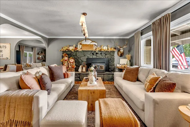 a living room with fireplace furniture and a chandelier