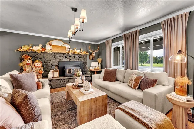 a living room with furniture dining area and a chandelier