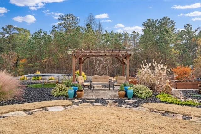 5320 North Helton Road Winston, GA 30187 - Photo 17 of 54 a view of a patio with a table and chairs under an umbrella