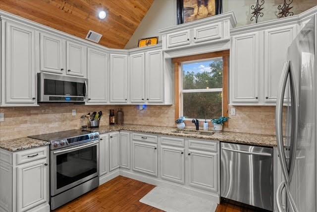 5320 North Helton Road Winston, GA 30187 - Photo 25 of 54 a kitchen with stainless steel appliances granite countertop a stove a sink and a microwave