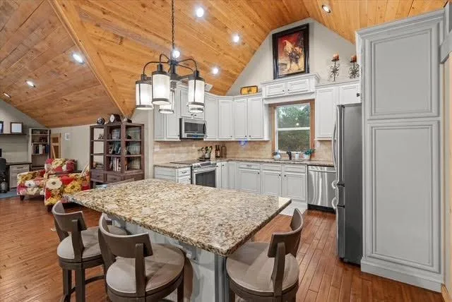 a bedroom with a bed and a wooden floor