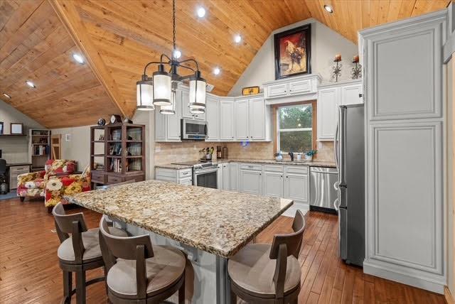 5320 North Helton Road Winston, GA 30187 - Photo 27 of 54 a kitchen with a table chairs refrigerator and cabinets