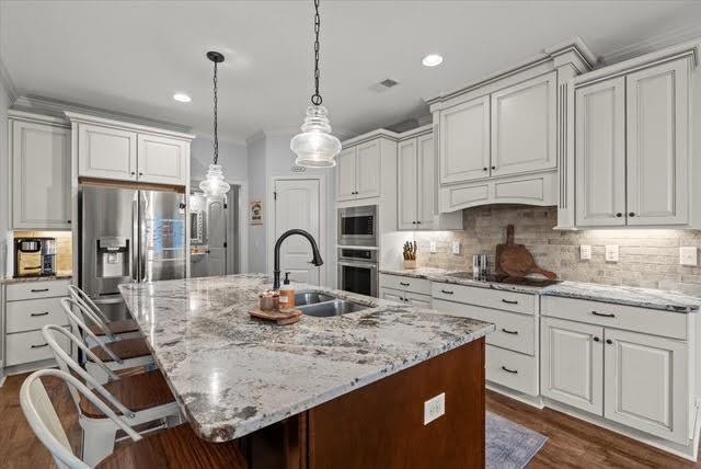 5320 North Helton Road Winston, GA 30187 - Photo 9 of 54 a kitchen with kitchen island granite countertop a sink a center island and cabinets