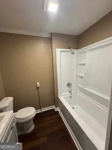 a bathroom with a bathtub and toilet