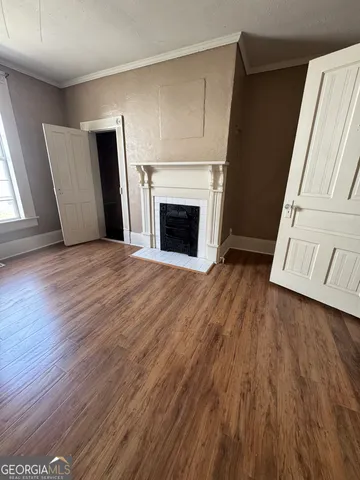 a view of a livingroom with wooden floor and fireplace