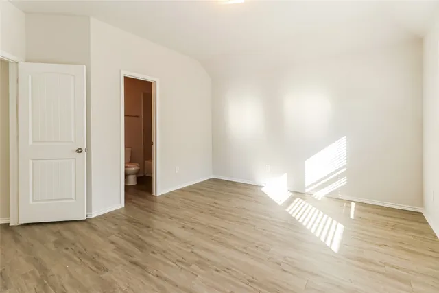 a view of an empty room and wooden floor