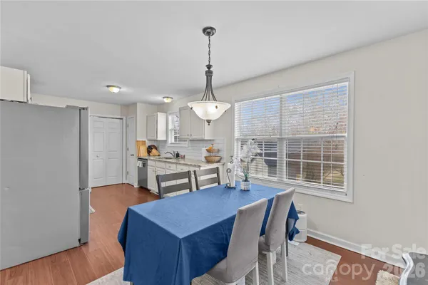 a view of a dining room with furniture window and wooden floor