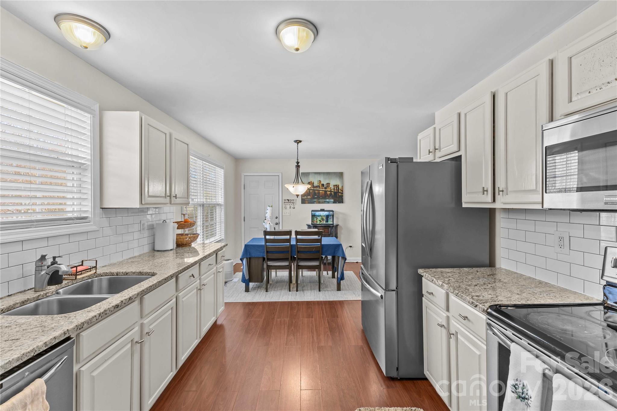 406 Calhoun Street Fort Mill, SC 29715 - Photo 16 of 44 a kitchen with granite countertop a refrigerator stove and sink