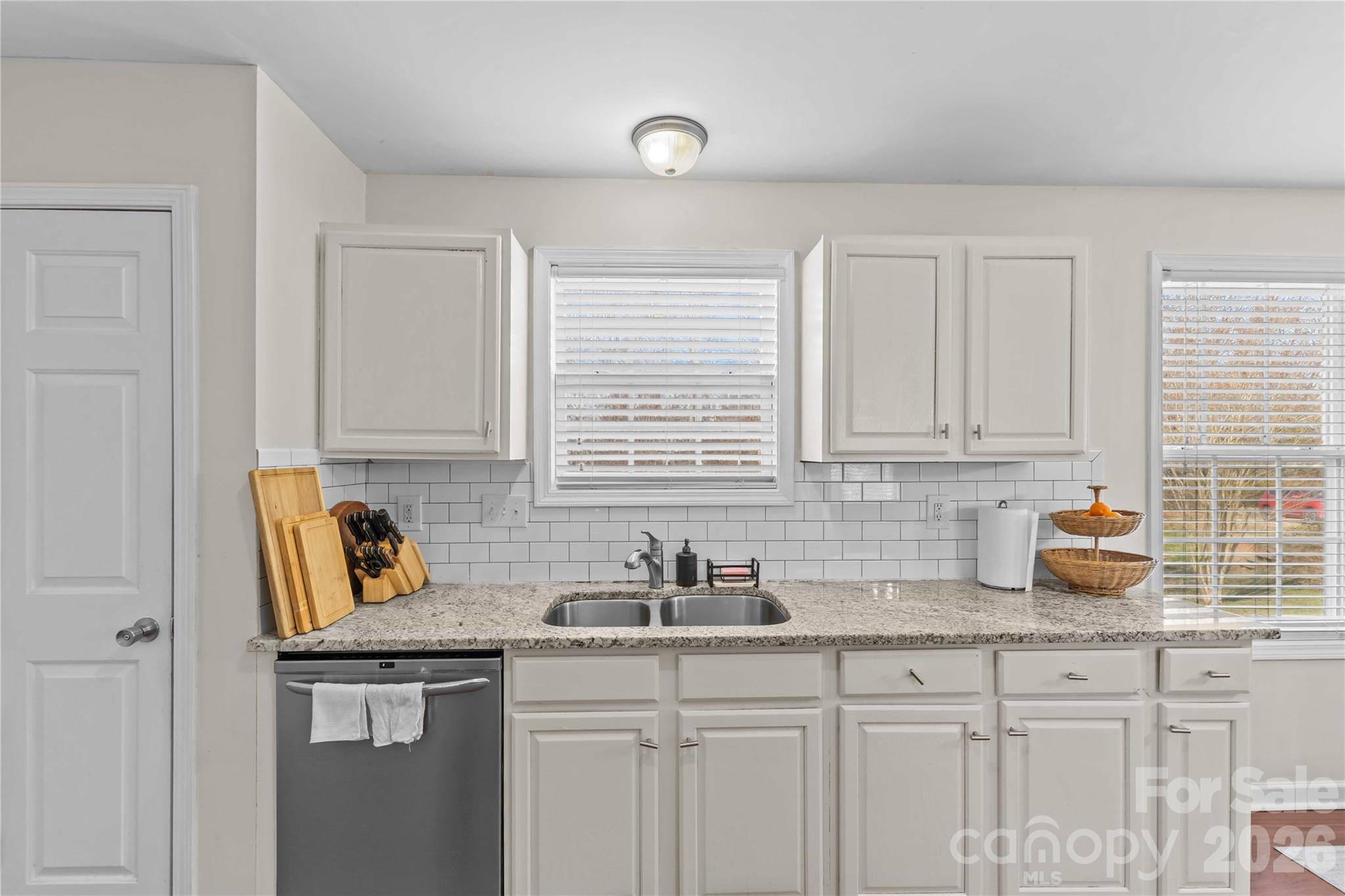 406 Calhoun Street Fort Mill, SC 29715 - Photo 17 of 44 a kitchen with stainless steel appliances granite countertop a sink a stove and cabinets
