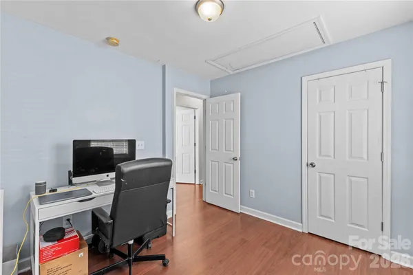 a view of a workspace with furniture and wooden floor