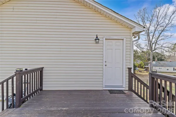 a view of a porch with wooden floor and fence