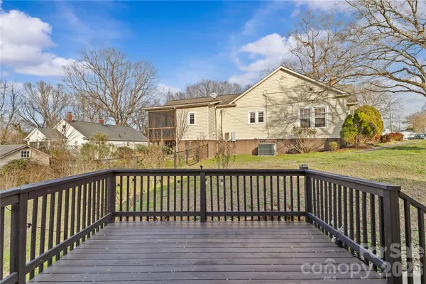 a view of a house with a wooden fence