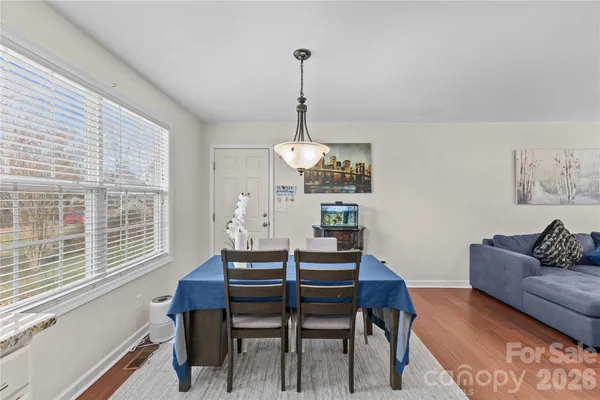 a dining room with furniture a chandelier and a rug