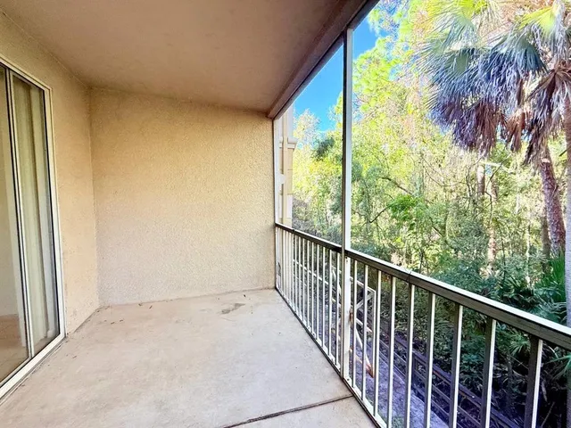 a view of balcony with wooden floor
