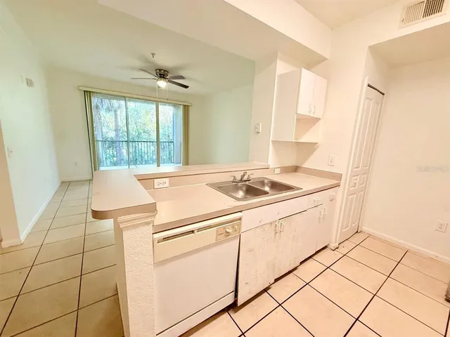 a view of washer and dryer with kitchen in the background
