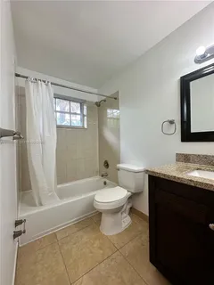 a bathroom with a double vanity sink toilet and shower