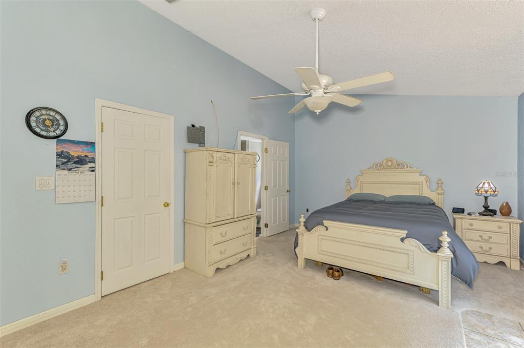 1137 Ponderosa Road Venice, FL 34293 - Photo 23 of 48 a bedroom with a bed and a ceiling fan