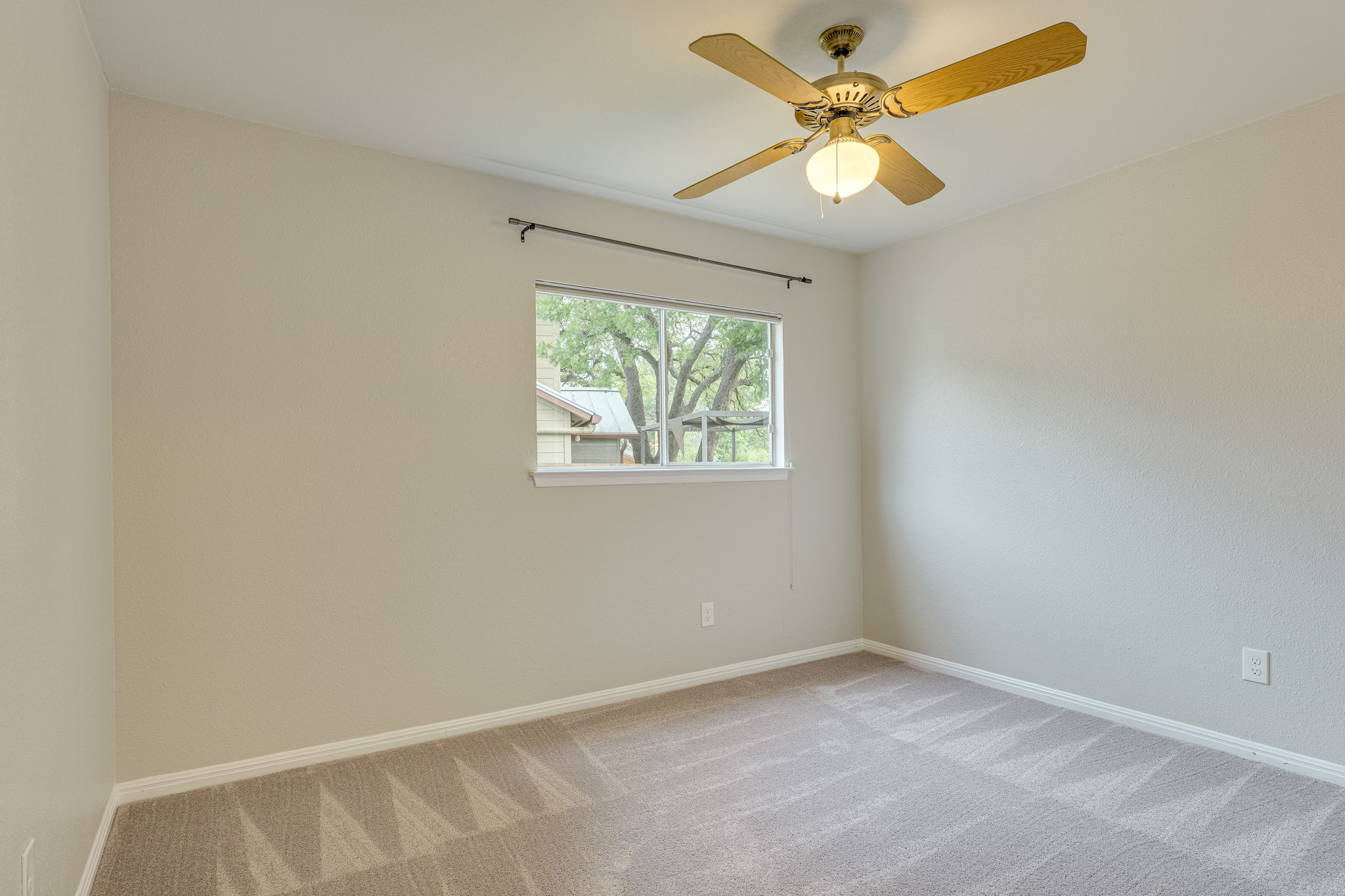 4815 Transit Circle Austin, TX 78727 - Photo 19 of 35 This bedroom overlooks the side and backyard and offers convenient access to the living room.