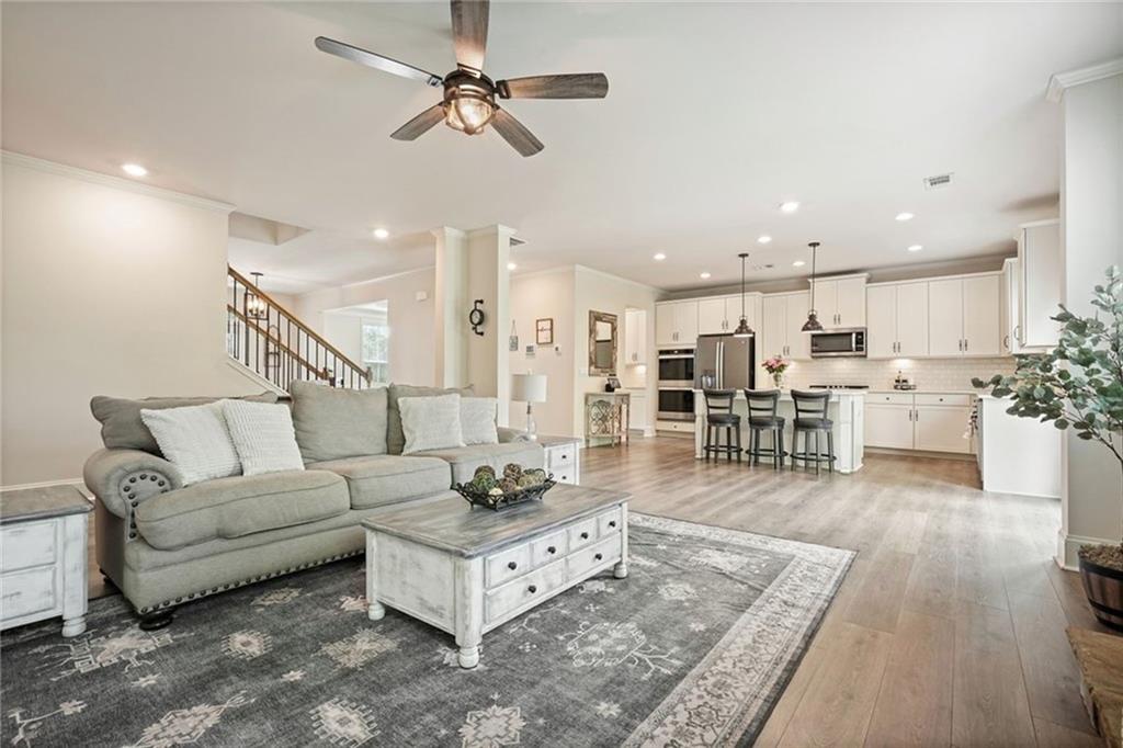 6915 Rambling Vale Dawsonville, GA 30534 - Photo 21 of 63 a living room with furniture and kitchen view