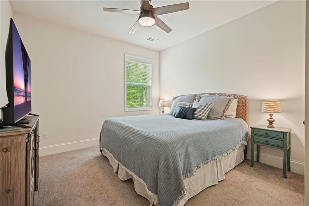 6915 Rambling Vale Dawsonville, GA 30534 - Photo 23 of 63 a bedroom with a bed and a flat tv screen on dresser