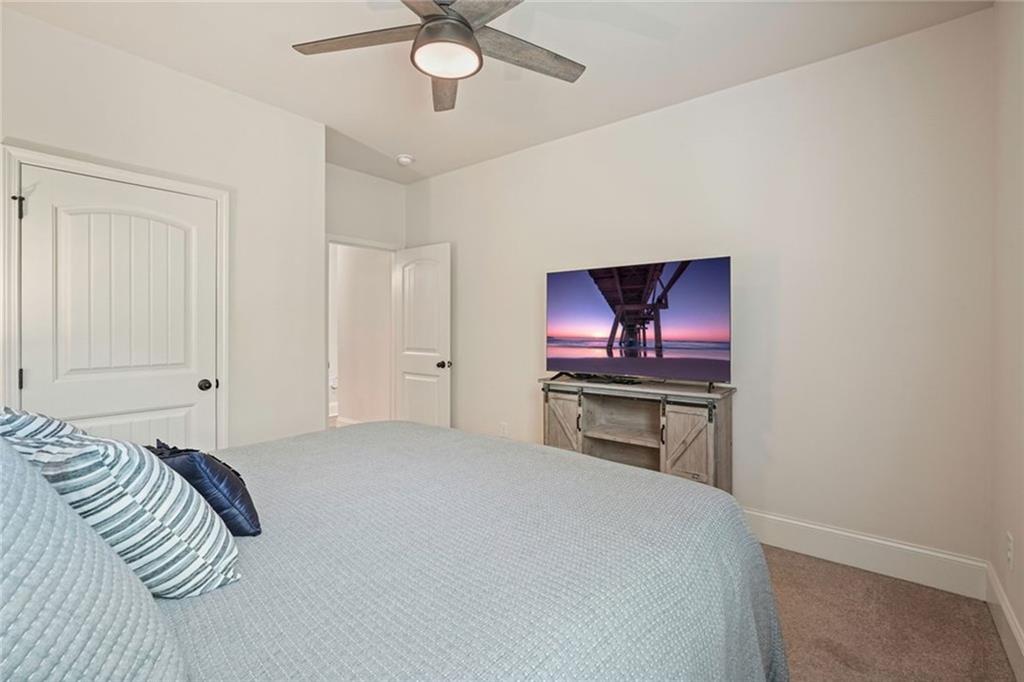 6915 Rambling Vale Dawsonville, GA 30534 - Photo 24 of 63 a bedroom with a bed and a chandelier