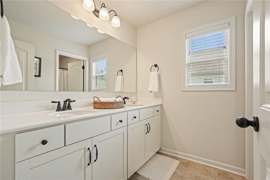 6915 Rambling Vale Dawsonville, GA 30534 - Photo 28 of 63 a bathroom with a double vanity sink mirror and