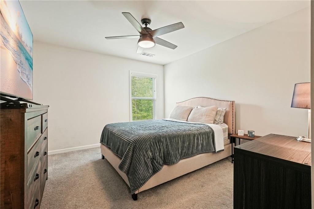 6915 Rambling Vale Dawsonville, GA 30534 - Photo 29 of 63 a bedroom with a bed and window