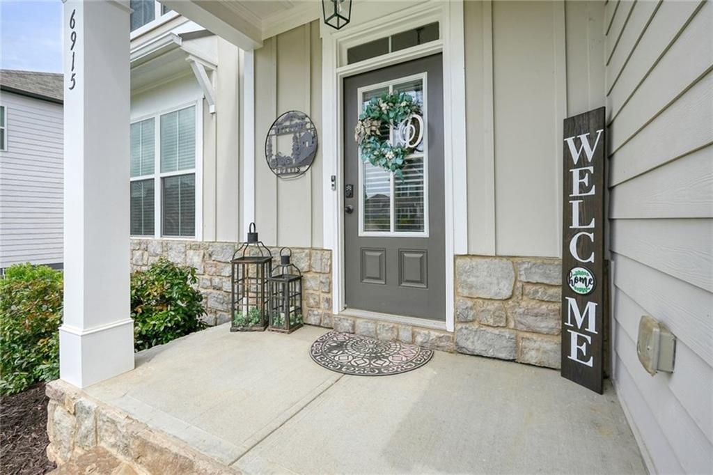 6915 Rambling Vale Dawsonville, GA 30534 - Photo 3 of 63 a front view of a house with outdoor seating and plants