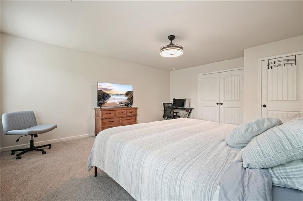 6915 Rambling Vale Dawsonville, GA 30534 - Photo 32 of 63 a bedroom with a bed a desk and chair