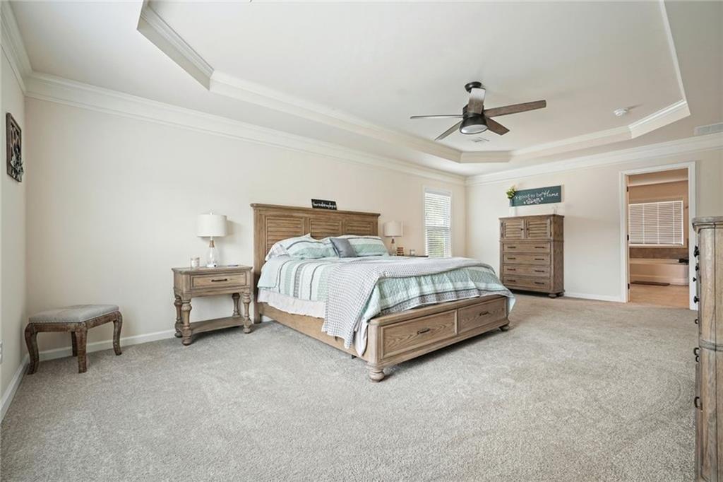 6915 Rambling Vale Dawsonville, GA 30534 - Photo 37 of 63 a bedroom with a bed and a table