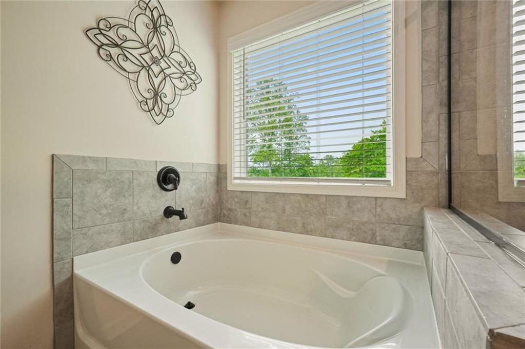 6915 Rambling Vale Dawsonville, GA 30534 - Photo 42 of 63 a bathroom with a bathtub