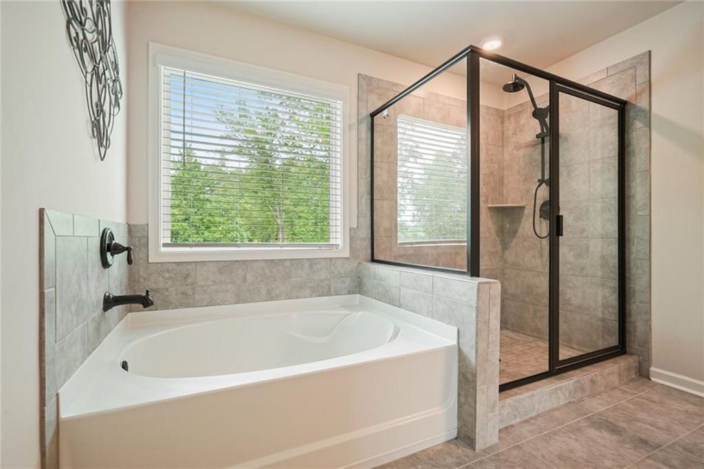 6915 Rambling Vale Dawsonville, GA 30534 - Photo 44 of 63 a white bath tub sitting next to a window