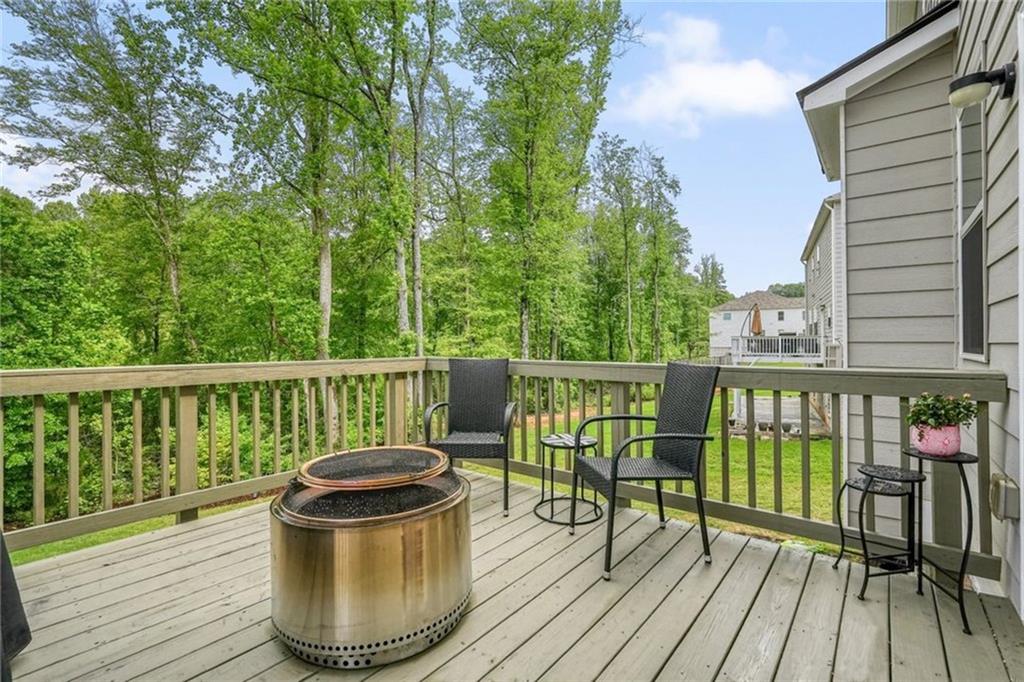 6915 Rambling Vale Dawsonville, GA 30534 - Photo 49 of 63 a view of a deck with two chair and wooden floor