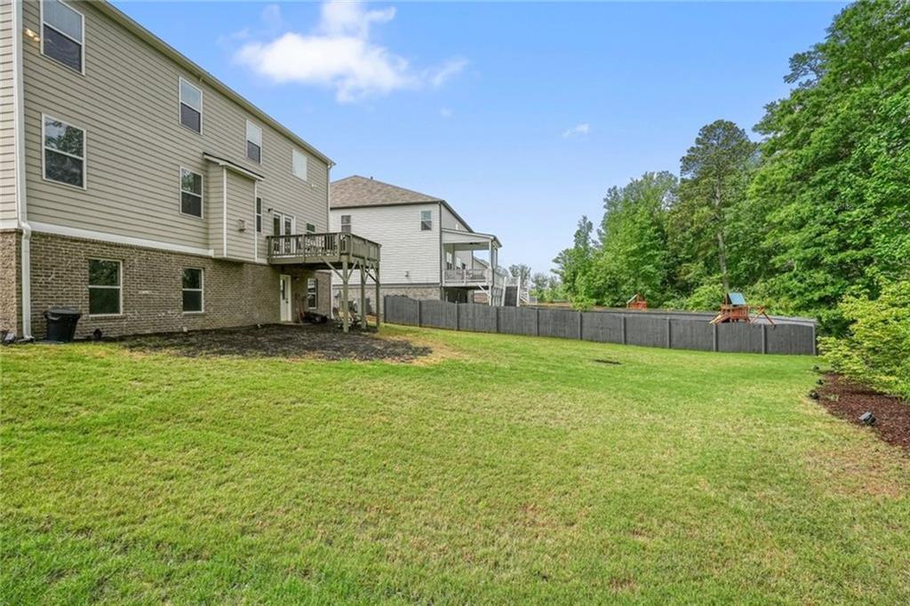 6915 Rambling Vale Dawsonville, GA 30534 - Photo 50 of 63 a house view with a sitting space and garden