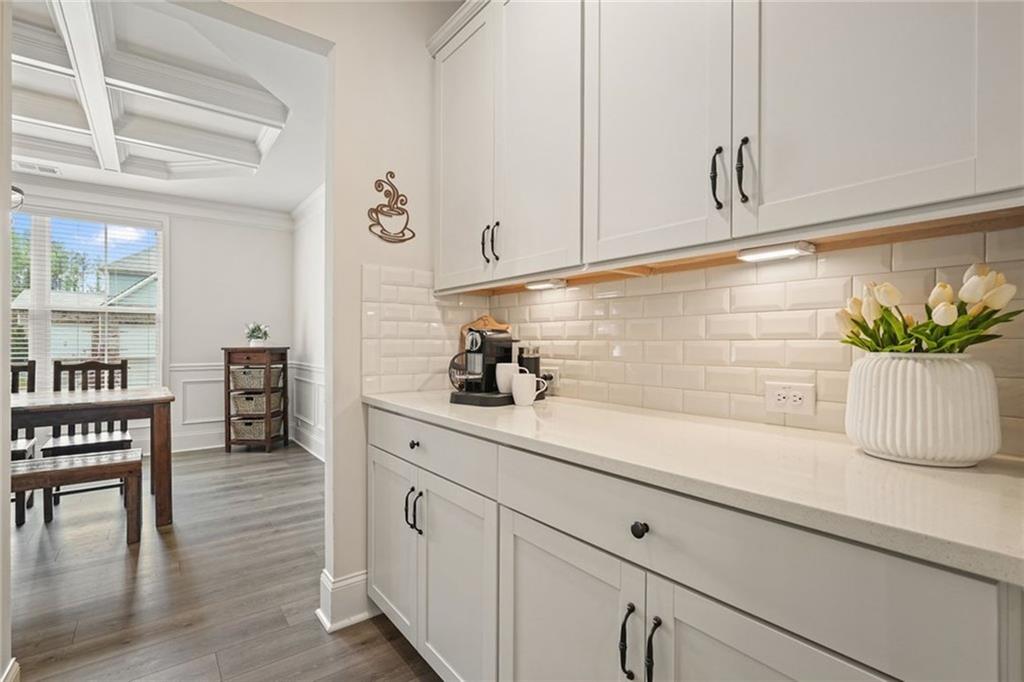 6915 Rambling Vale Dawsonville, GA 30534 - Photo 8 of 63 a kitchen with stainless steel appliances white cabinets and a potted plant