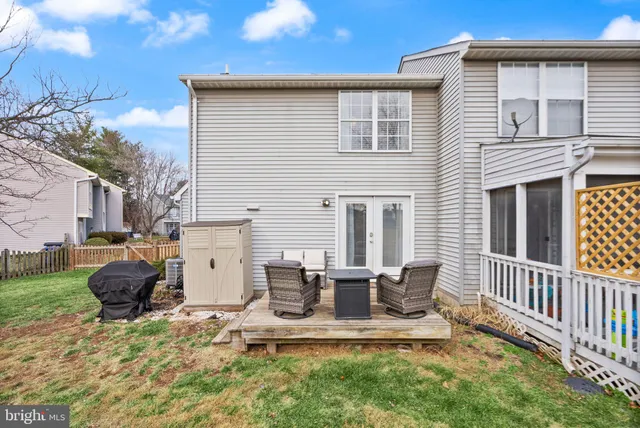 a view of a house with backyard and a tree