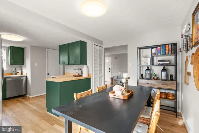 a living room with furniture and a kitchen view