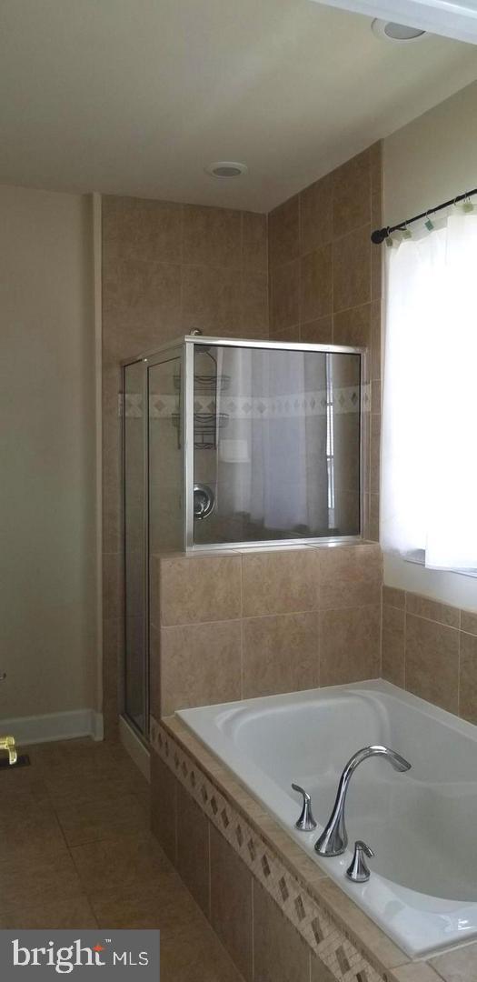 13595 Station Street Germantown, MD 20874 - Photo 4 of 7 a bathroom with a bathtub and a shower
