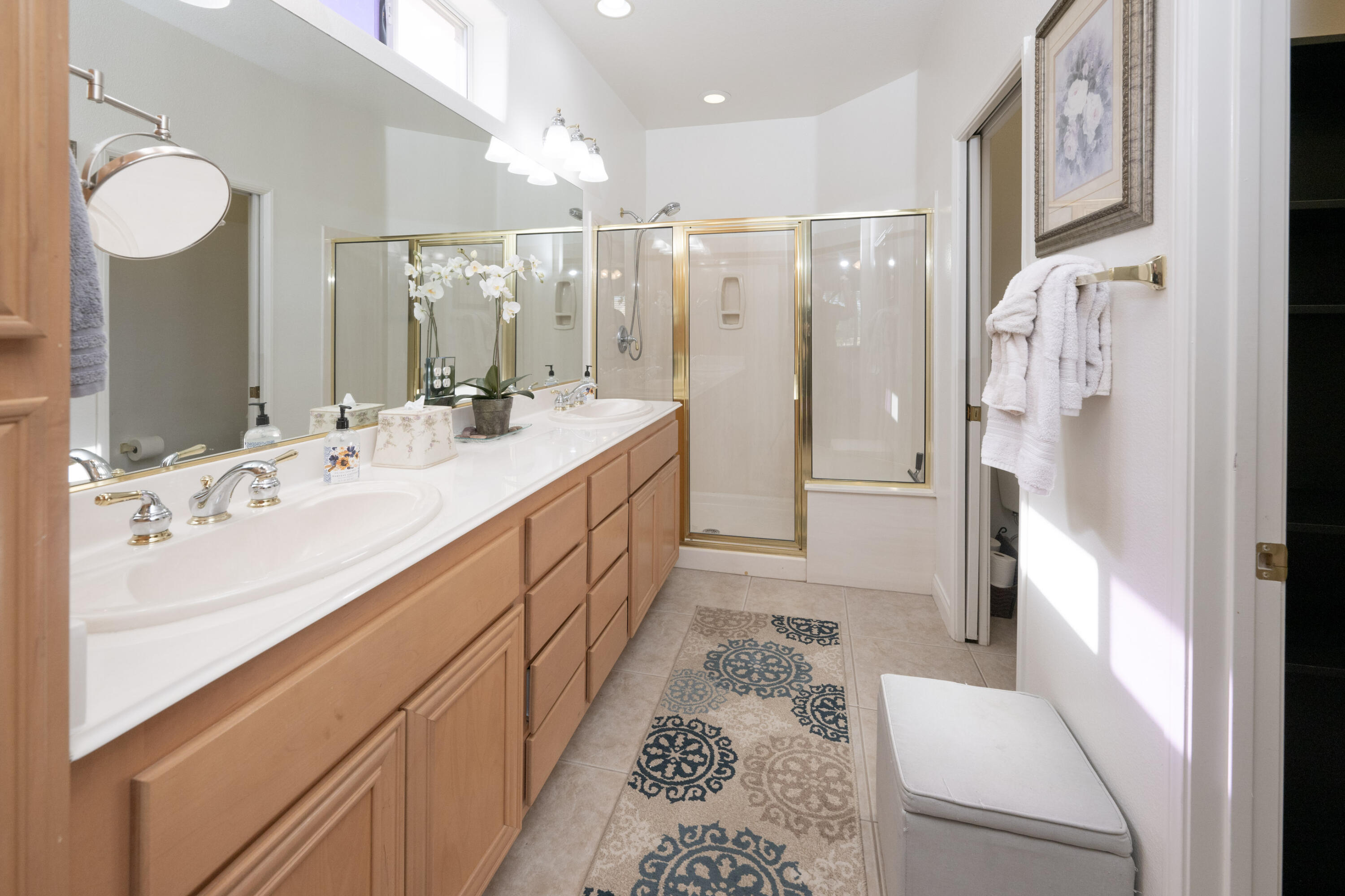 45138 Banff Springs Street Indio, CA 92201 - Photo 13 of 38 a bathroom with a double vanity sink mirror and shower