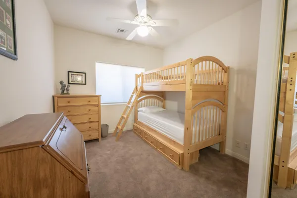 a bedroom with a bed and a dresser