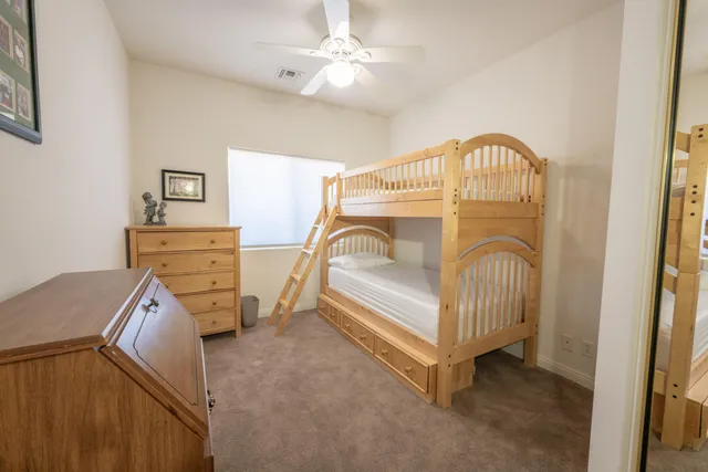 a bedroom with a bed and a dresser
