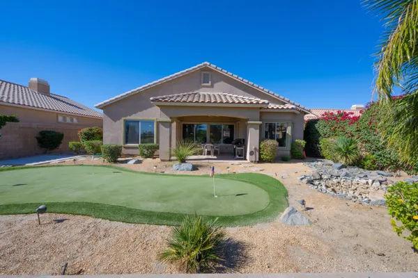 a view of a house with backyard porch and sitting area