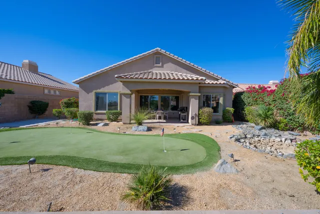 a view of a house with backyard porch and sitting area